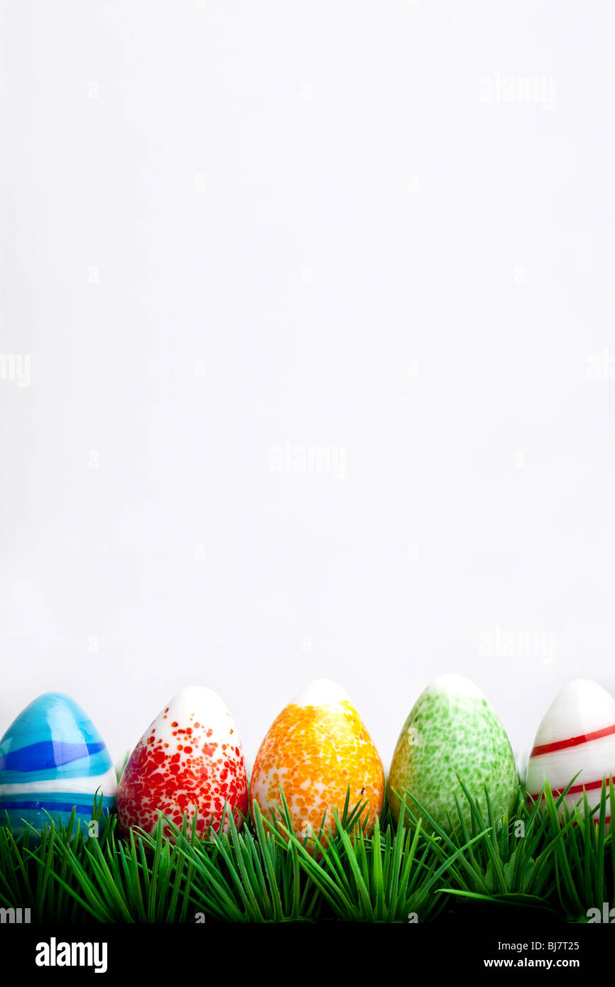 Easter eggs in green grass isolated on white background Stock Photo - Alamy