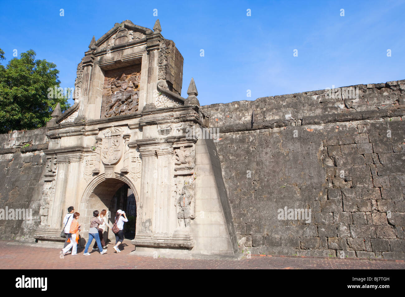 Group of tourists walking through Fort Santiago gate; Intramuros; Manila; Philippines Stock Photo