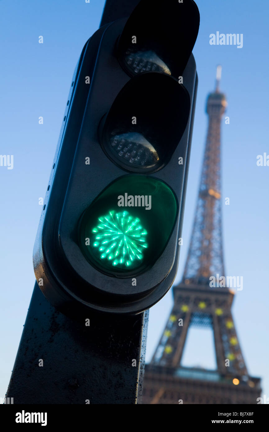 Green french traffic light / signal in Paris, with the Eiffel Tower behind. France. Stock Photo