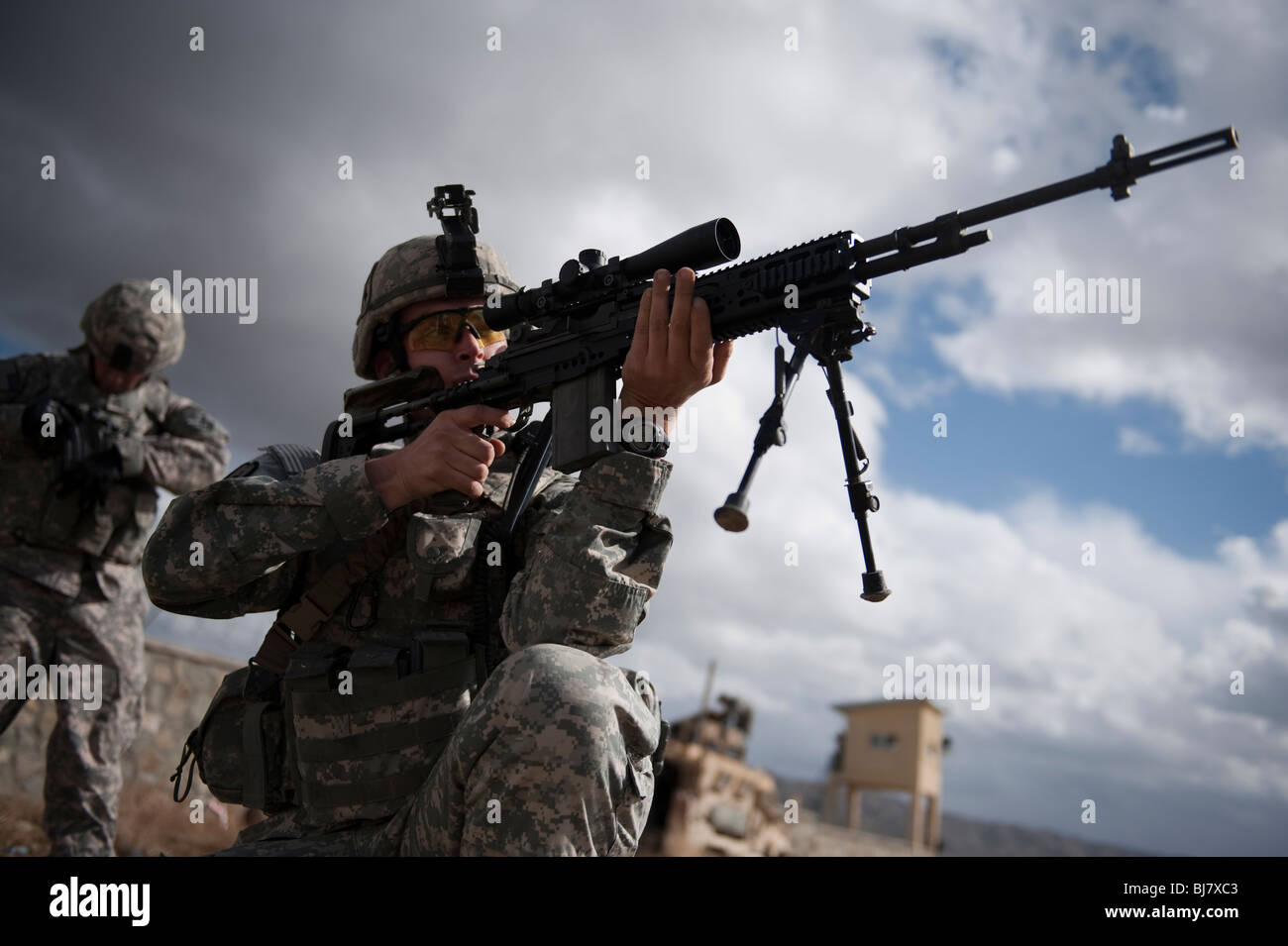Army Sniper prepares to fire Stock Photo
