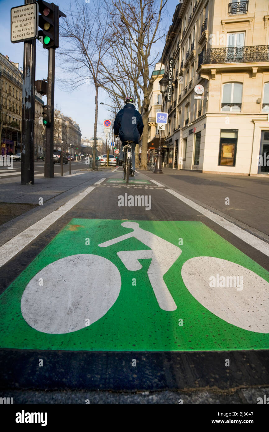 Cyclist cycles along a French bicycle / bike / cycle / lanes / lane in