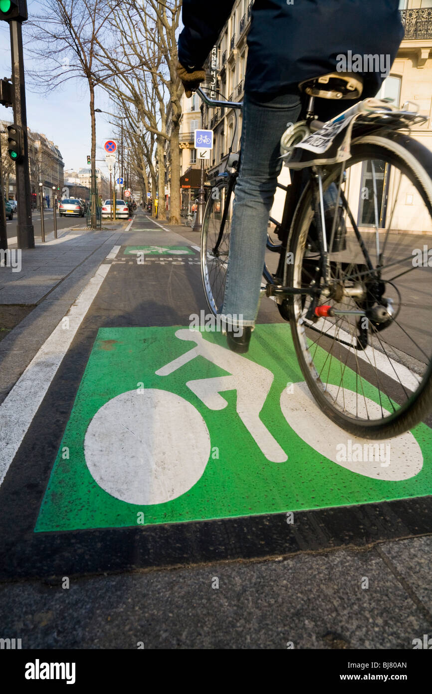 Cyclist cycles along a French bicycle / bike / cycle / lanes / lane in