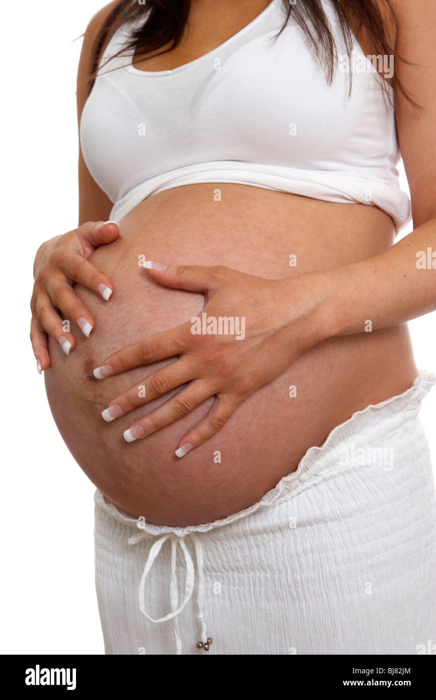 8 month pregnant woman 30 years of age with baby bump Stock Photo