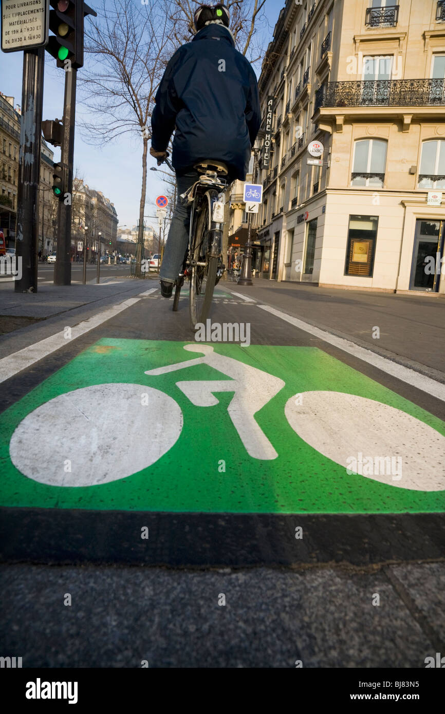 Cyclist cycles along a French bicycle / bike / cycle / lanes / lane in
