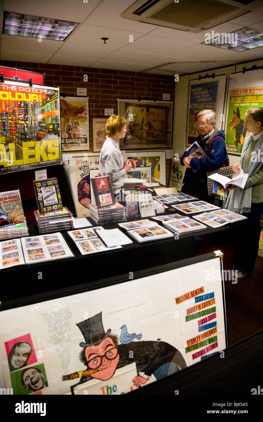 Exhibitor / stall selling vintage posters, & two customers, at the