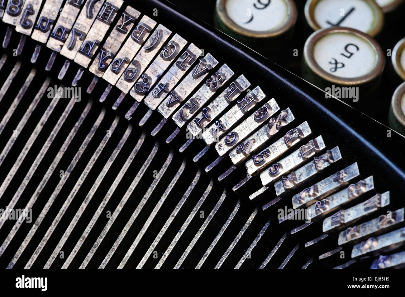 Close-up detail of the type of an old German, pre-war typewriter with the keys out of focus in the background. Stock Photo