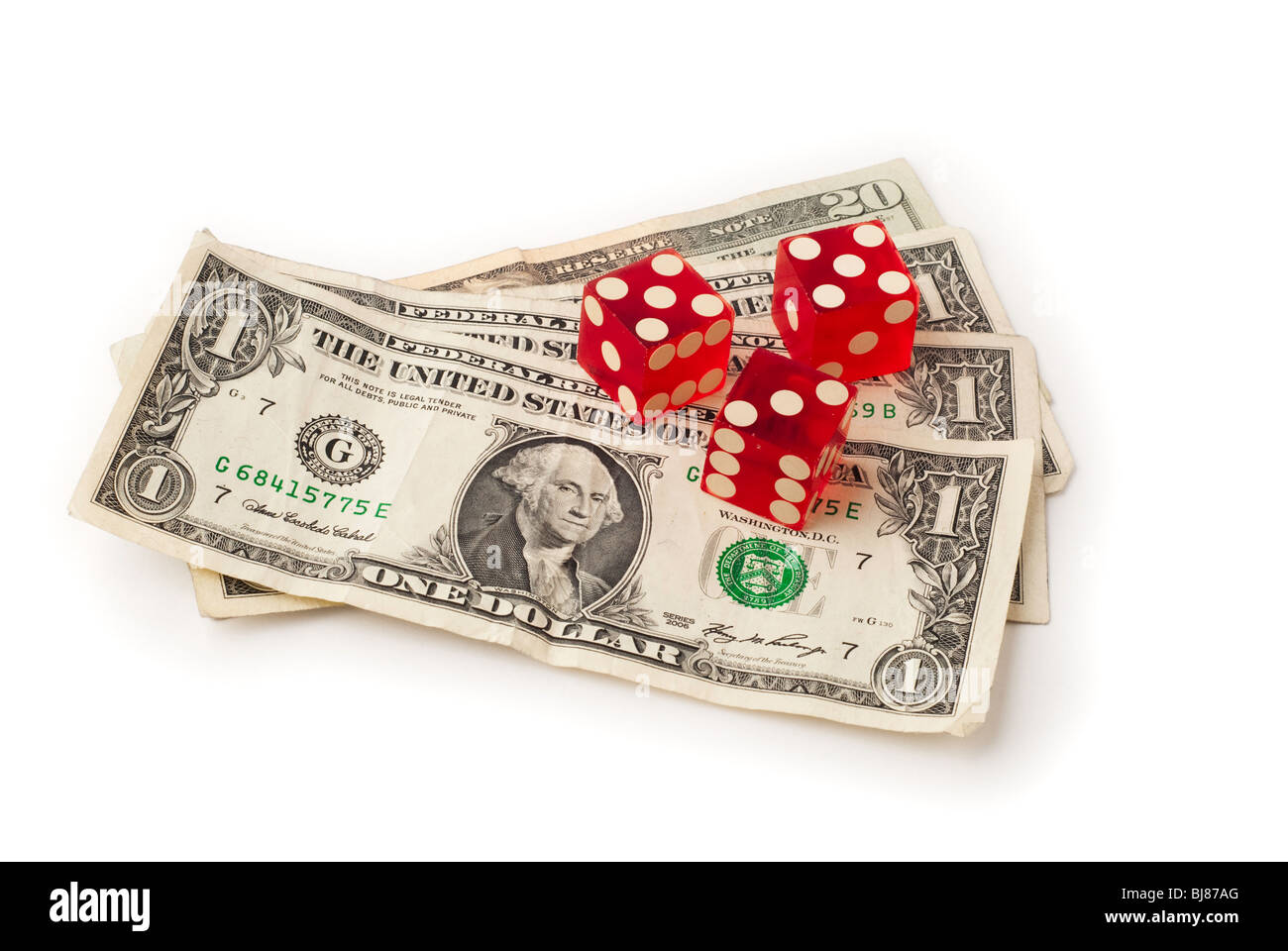 Three dice and some dollar bills shown from a slight overhead angle on white background. Saved