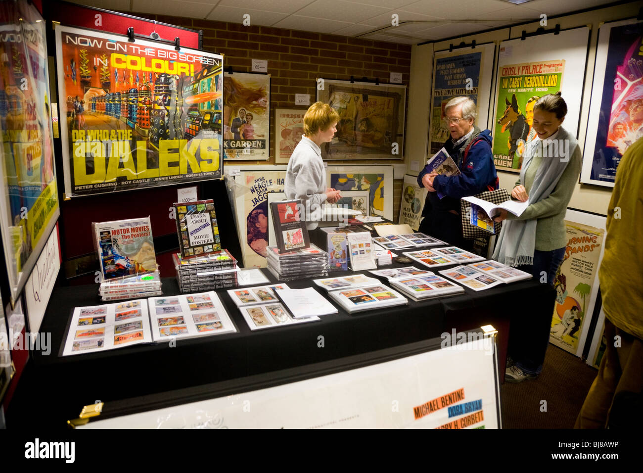 Exhibitor / stall selling vintage posters, & two customers, at the