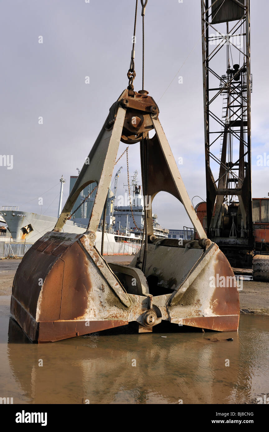 Huge opening clamshell bucket loader on crane Stock Photo