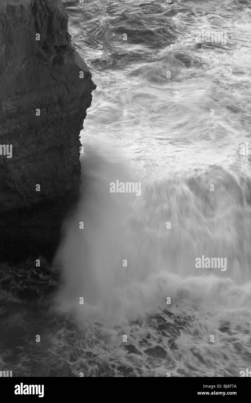 The raging waves endlessly crush into rocks at the Great Ocean Road in Victoria, Australia. Stock Photo