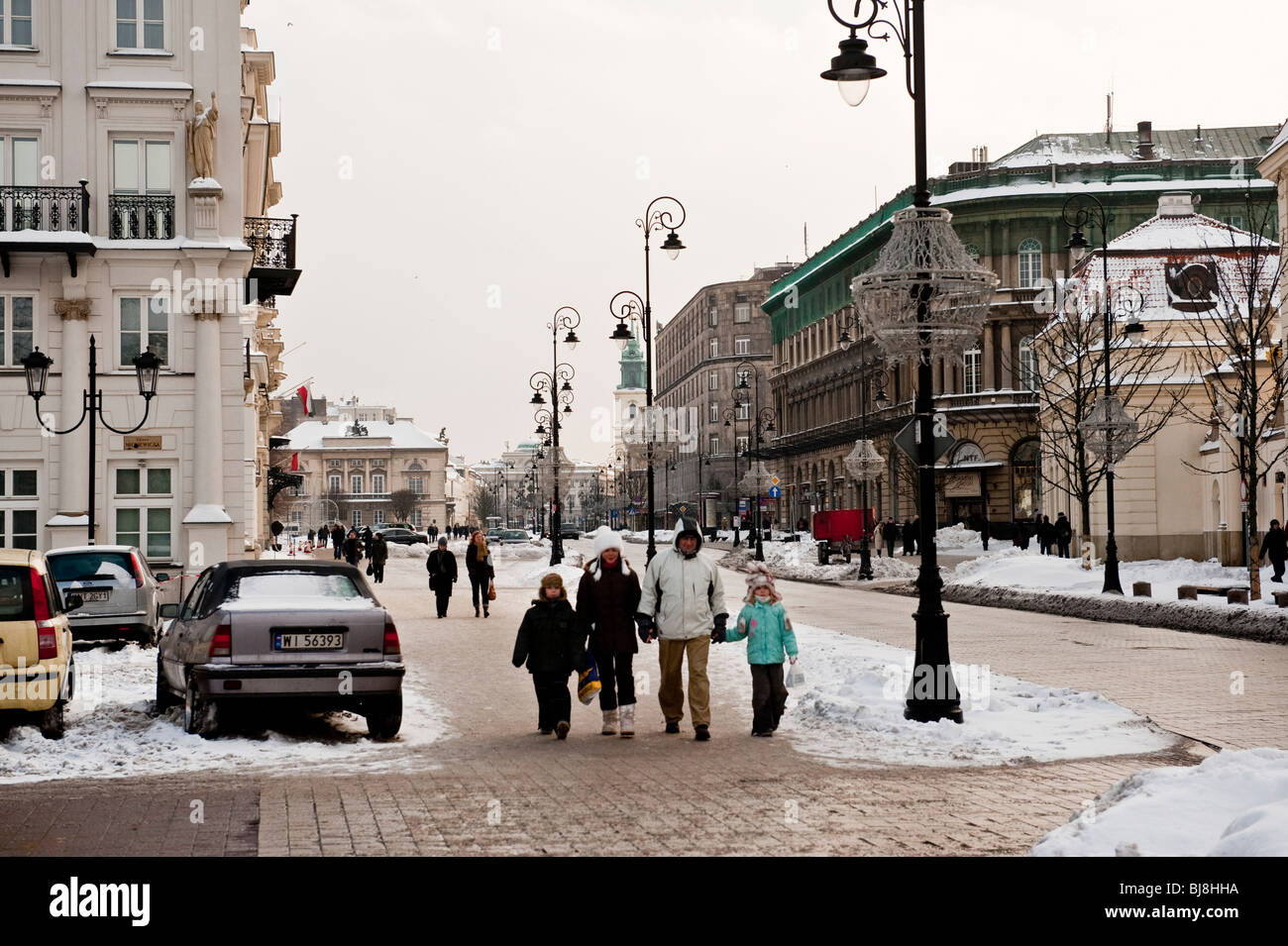 Family out for a winter Sunday stroll on Nowy Swiat street in central Warsaw Poland Stock Photo