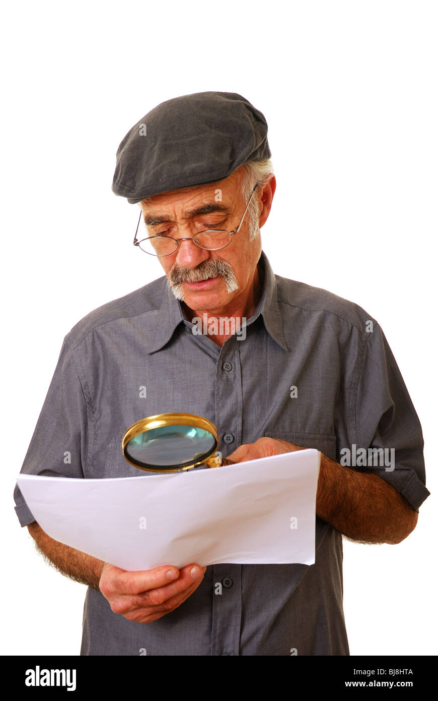Elderly Man Using Glasses And Magnifying Glass To Read Small Print