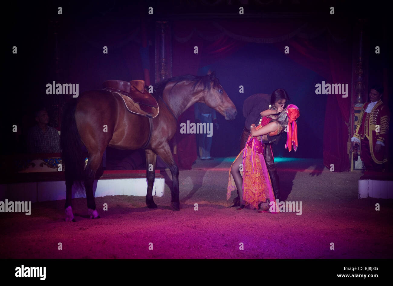 A romanian Gypsy horse trainer kisses his girl. Circus Roncalli. Munich, Germany Stock Photo