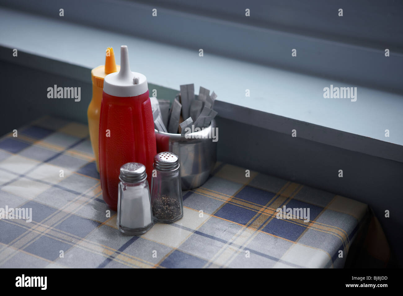 sauce bottles on cafe table Stock Photo