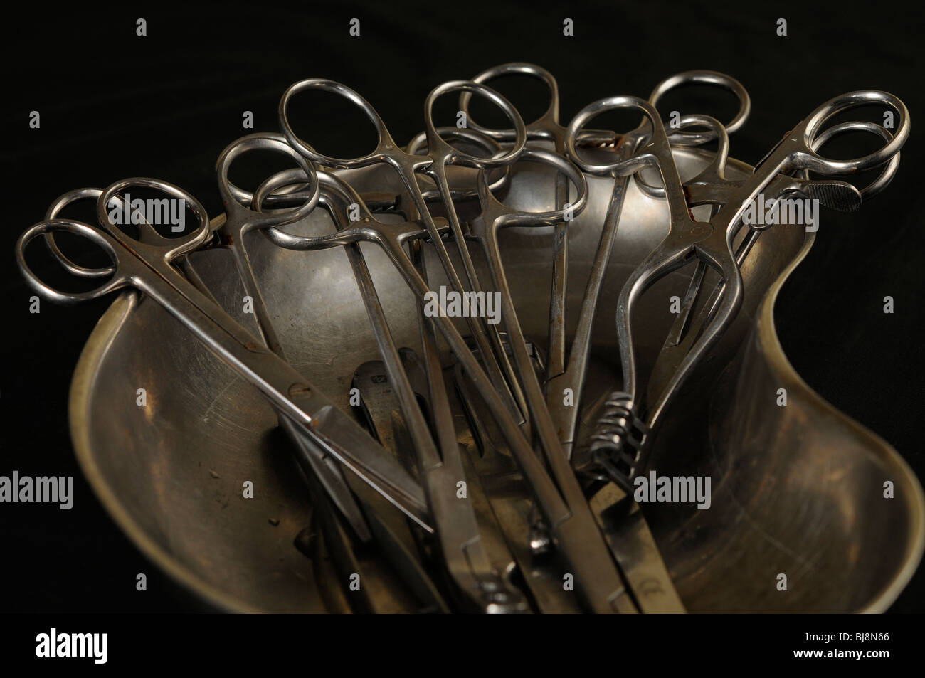 Stainless steel medical instruments laid out in a kidney dish used for embalming Stock Photo