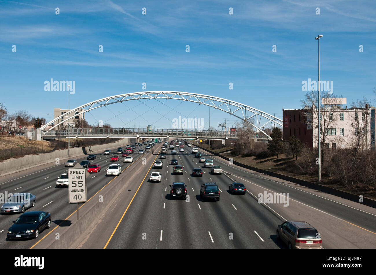 Interstate highway 25 running through Denver Colorado showing car traffic and the Highland Pedestrian Bridge Stock Photo