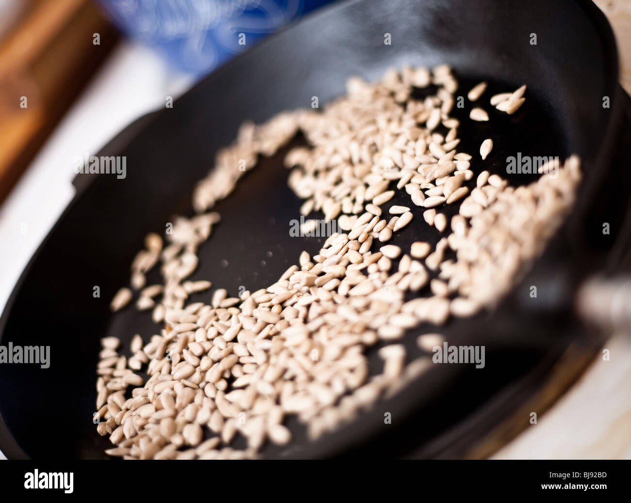 Sunflower seeds roasting in a frying pan Stock Photo Alamy