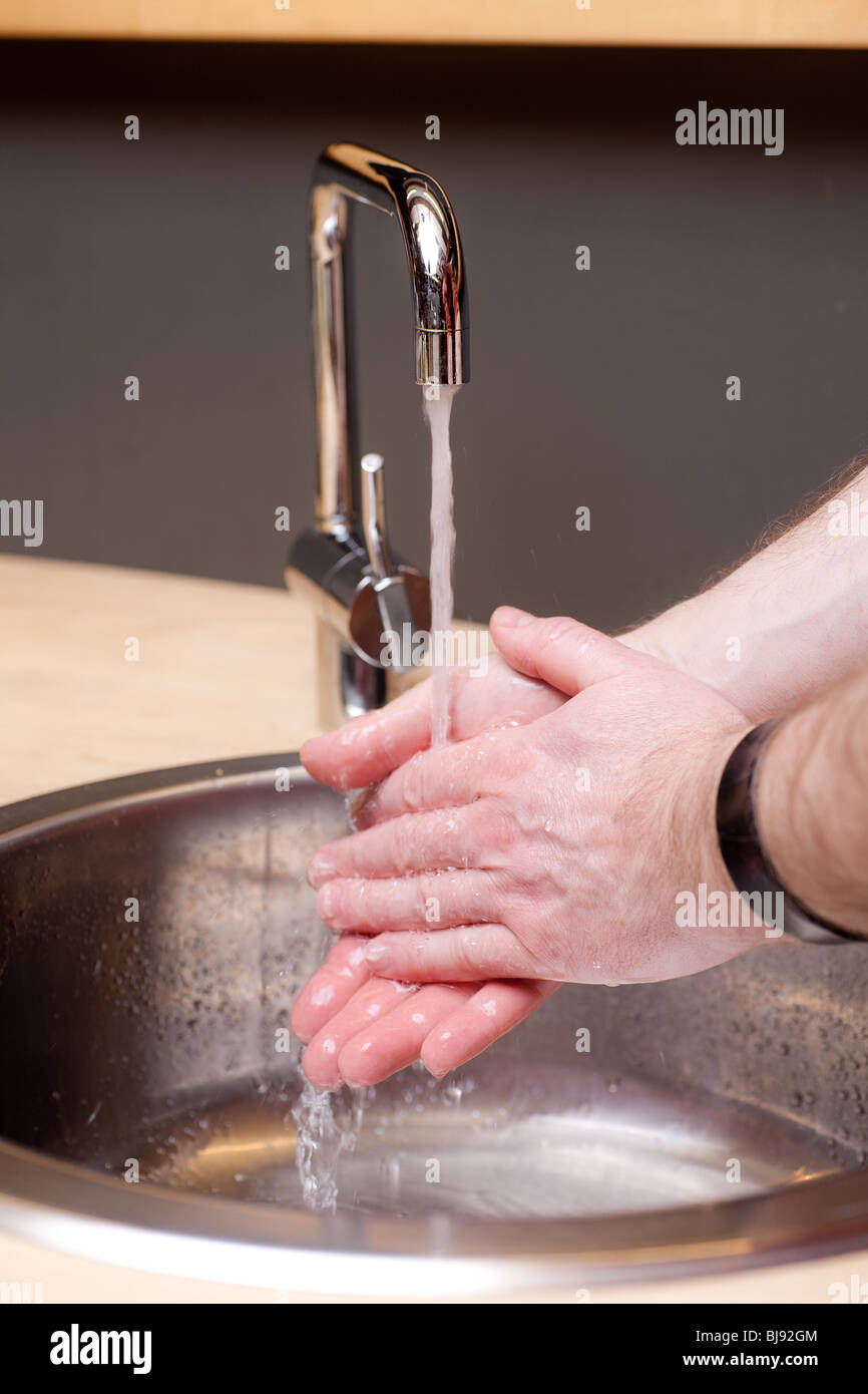 Male hands washing under running water Stock Photo - Alamy