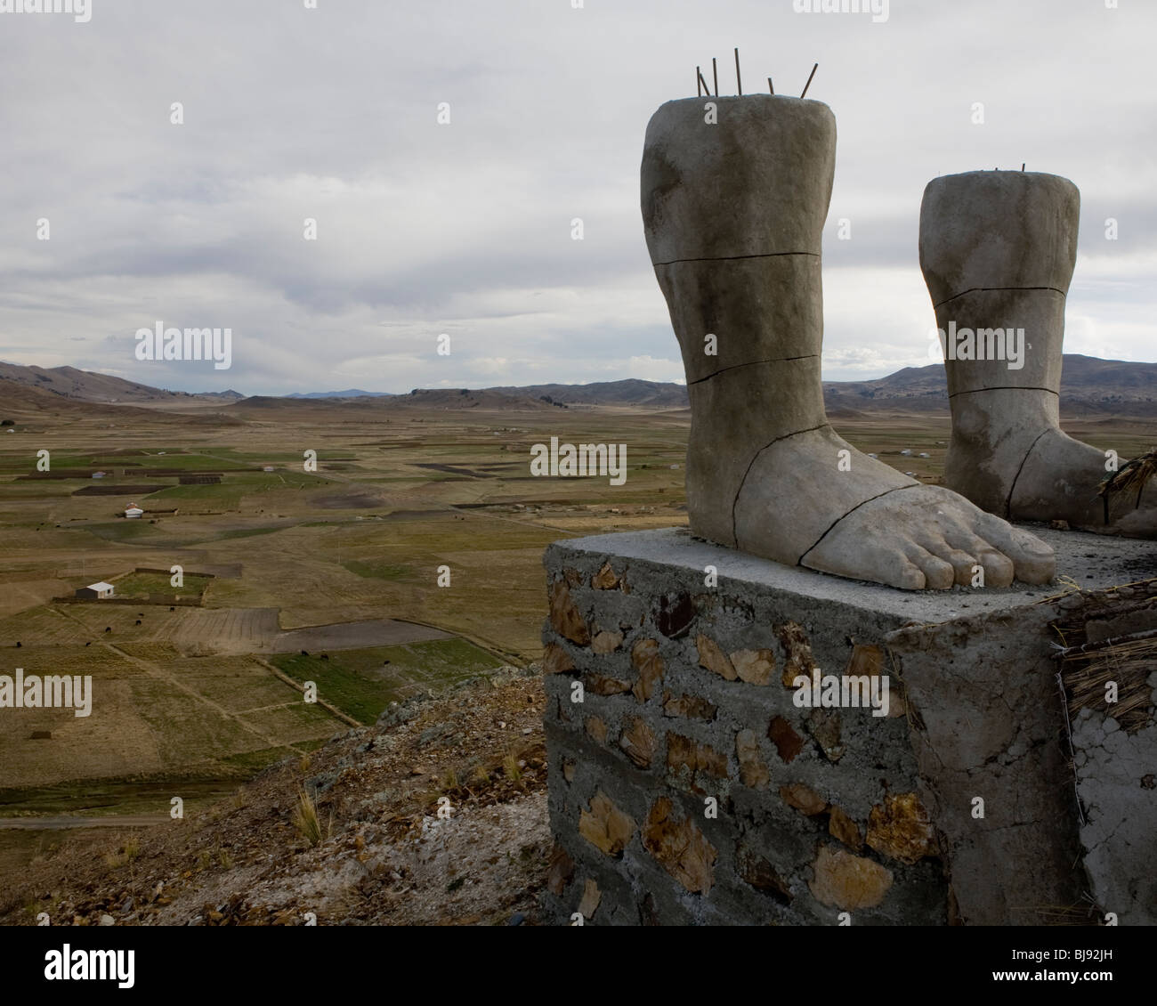 The feet of unfinished monument to indigenous hero Bartolina Sisa towering over the Bolivian altiplano in the Andes Stock Photo