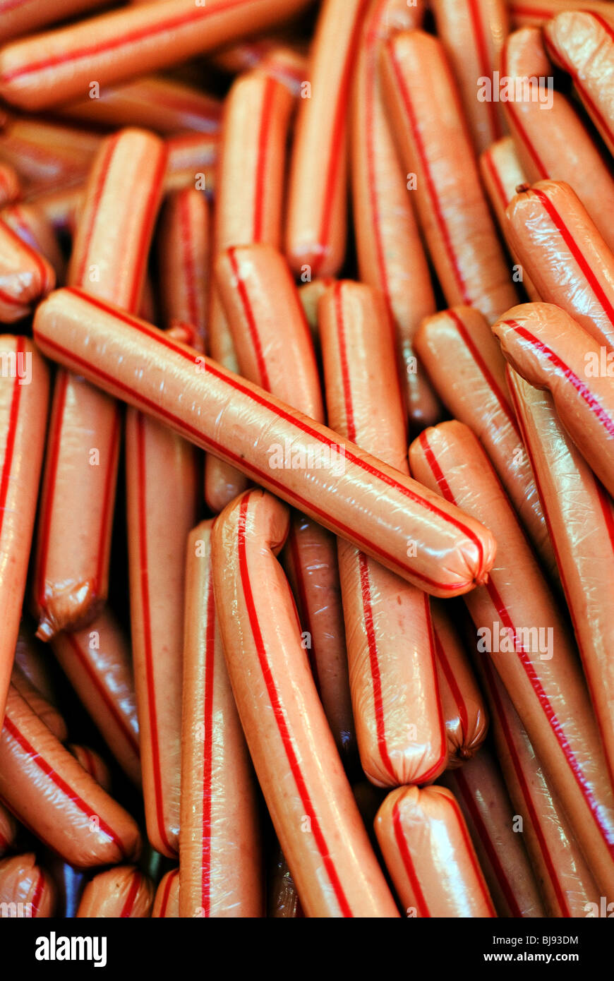 a-pile-of-uncooked-hot-dog-sausages-individually-wrapped-stock-photo