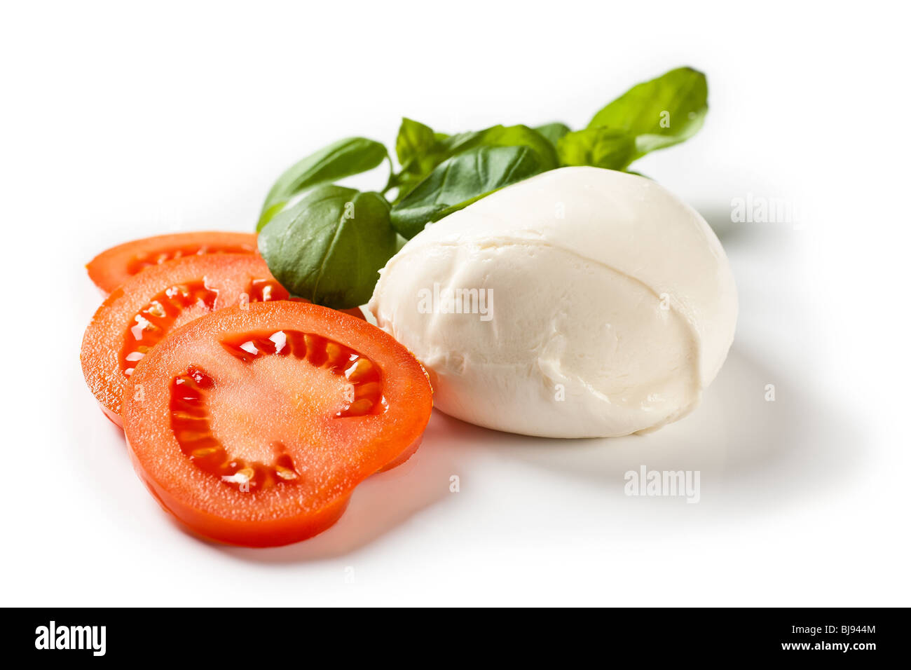 Mozarella cheese with tomatoe slices and basil Stock Photo
