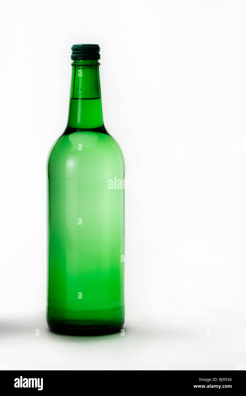Green alcohol bottle on shiny white background Stock Photo - Alamy