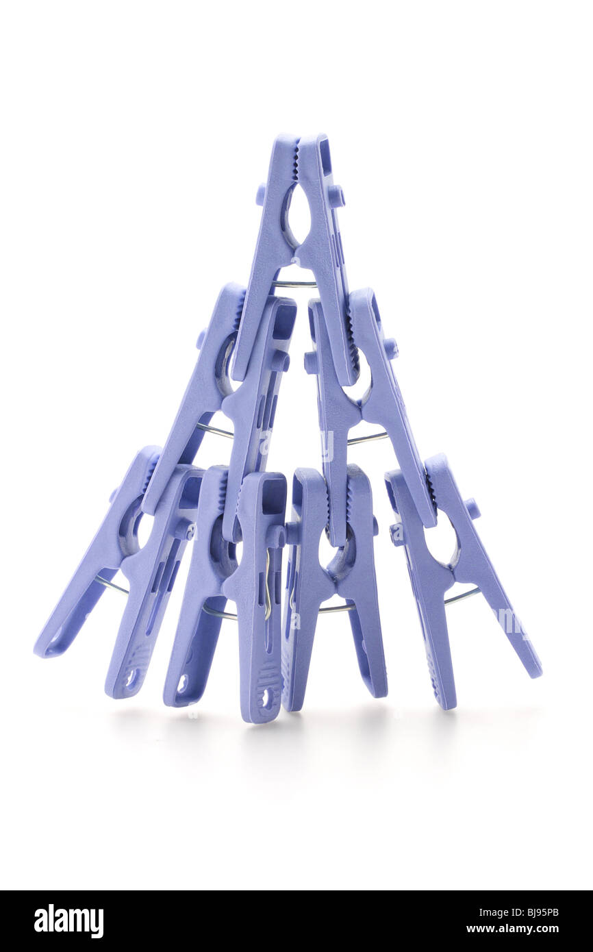 Plastic clothes pegs assembled in shape of pyramid on white background Stock Photo