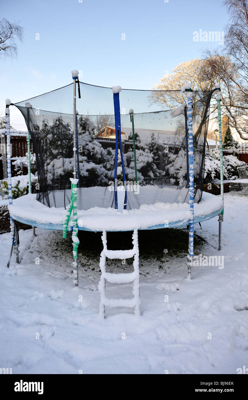 Large child's trampoline covered in deep snow in winter Stock Photo Alamy
