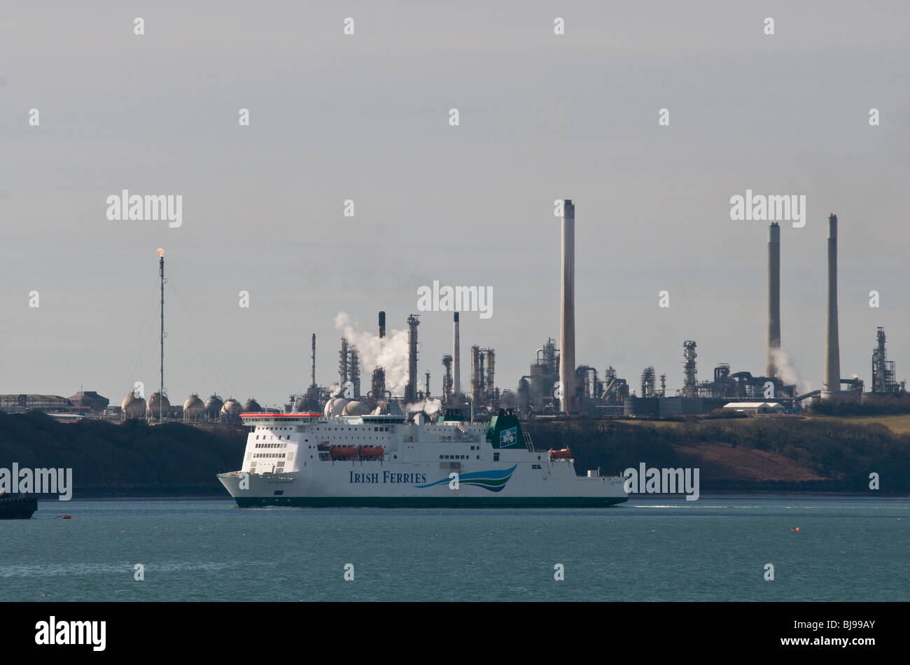 The Irish Ferry, Isle of Inishmore, making its way up the River Cleddau Estuary in Pembrokeshire past the Chevron oil refinery Stock Photo