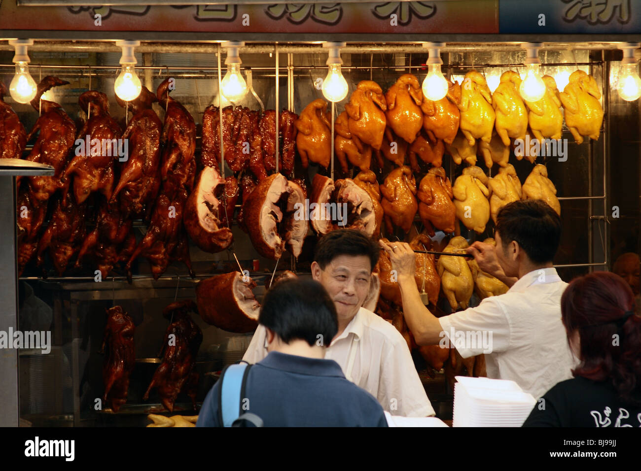 Restaurant in Hong Kong showing roasted duck peking style and roasted pork. Stock Photo