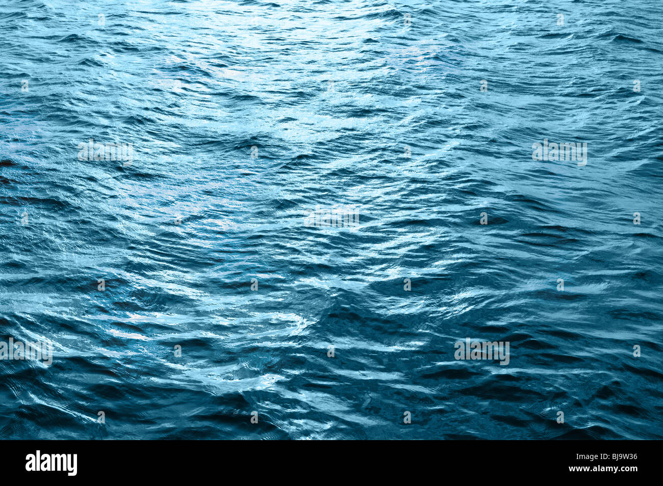 Sea water surface with ripple and cloud reflections Stock Photo