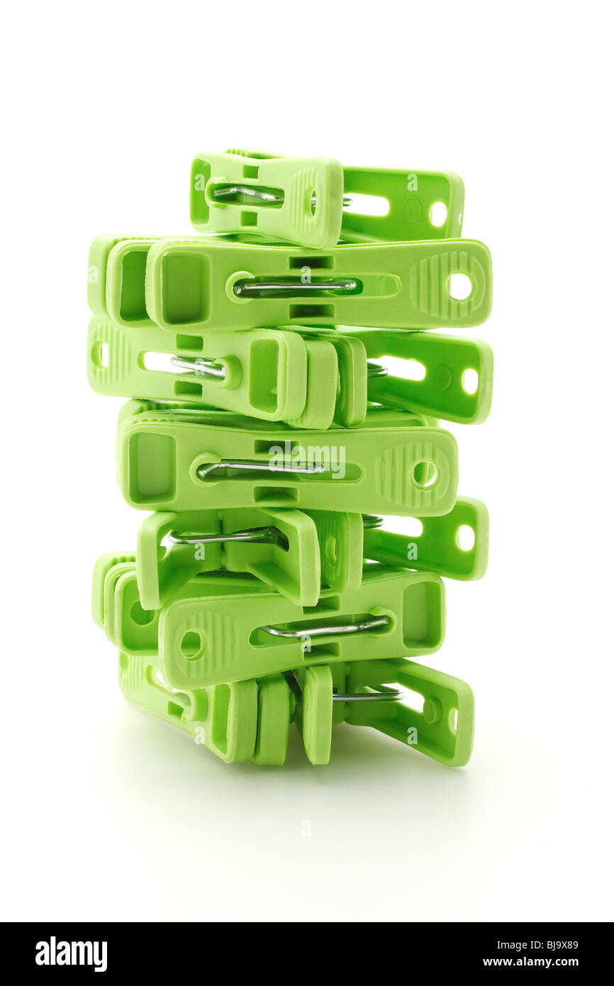Plastic clothes pegs tower on white background Stock Photo