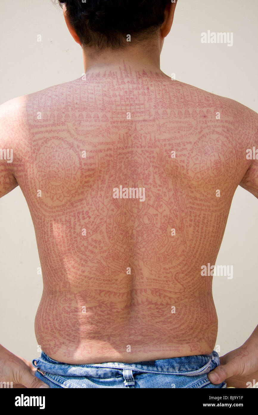 Back view of red ink tattoos at Wat Bang Phra temple in Thailand, where  monks tattoo their devotees Stock Photo - Alamy