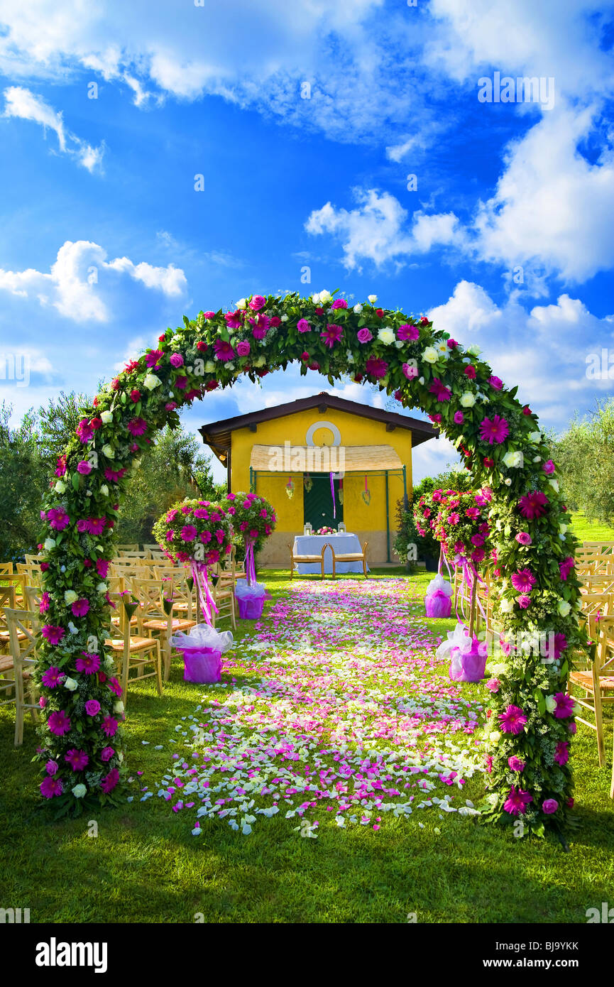 The wedding venue with a flower arch and a petal path Stock Photo Alamy