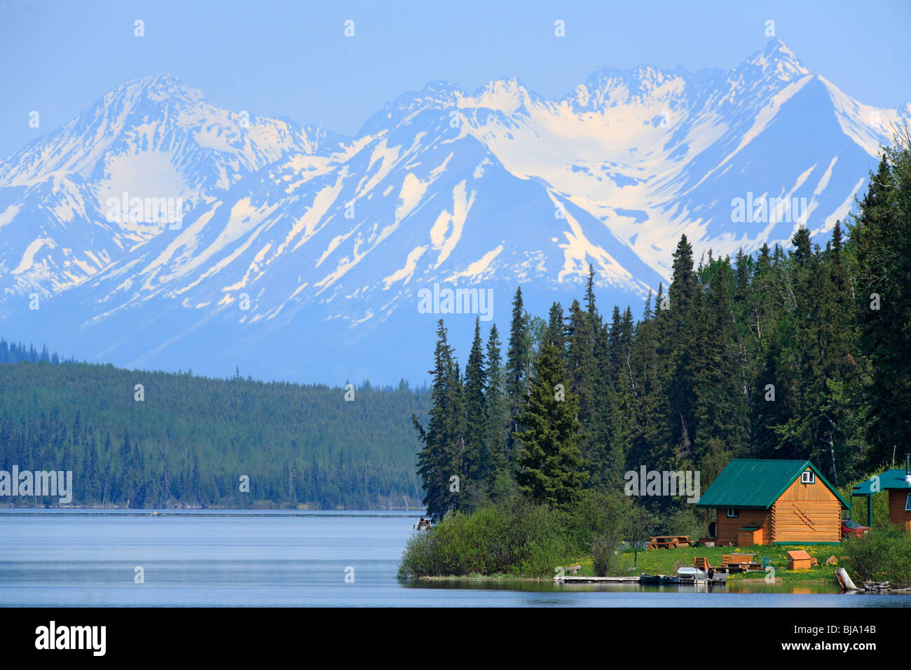 Cabins with mountains in background, Chapman lake, British Columbia