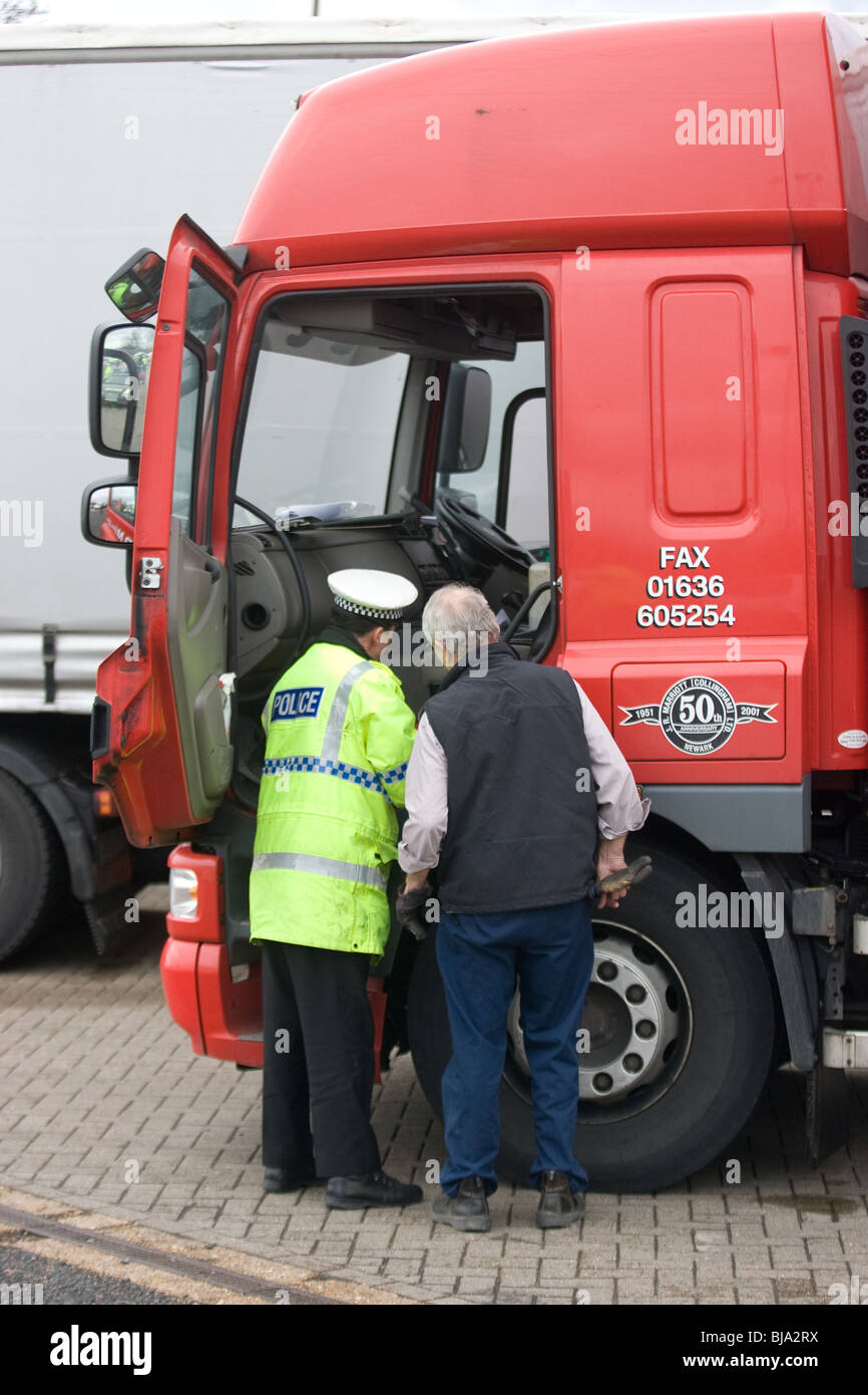 A Police officer talking to a lorry driver Stock Photo