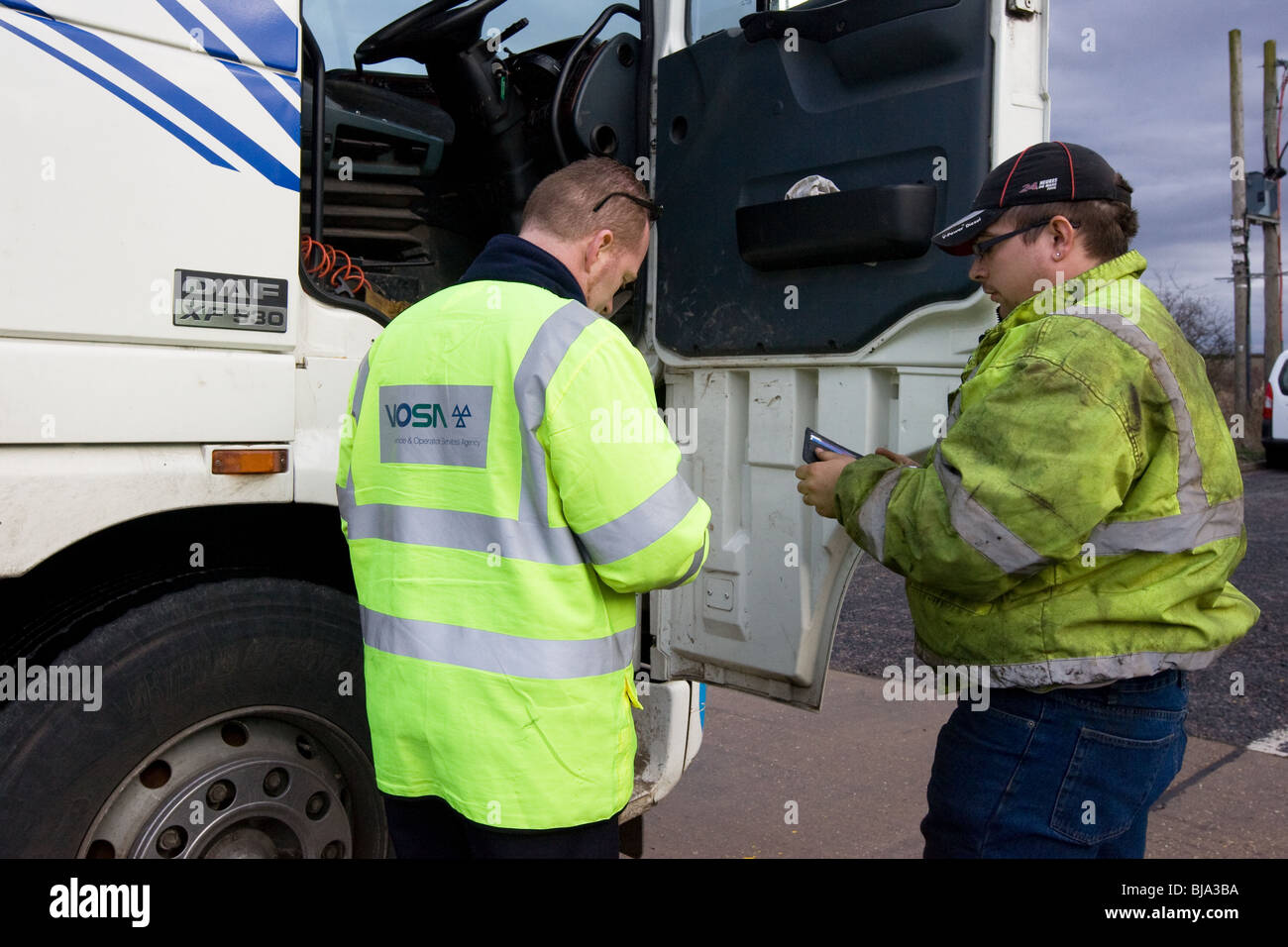 A VOSA Officer talking To A Lorry Driver Stock Photo