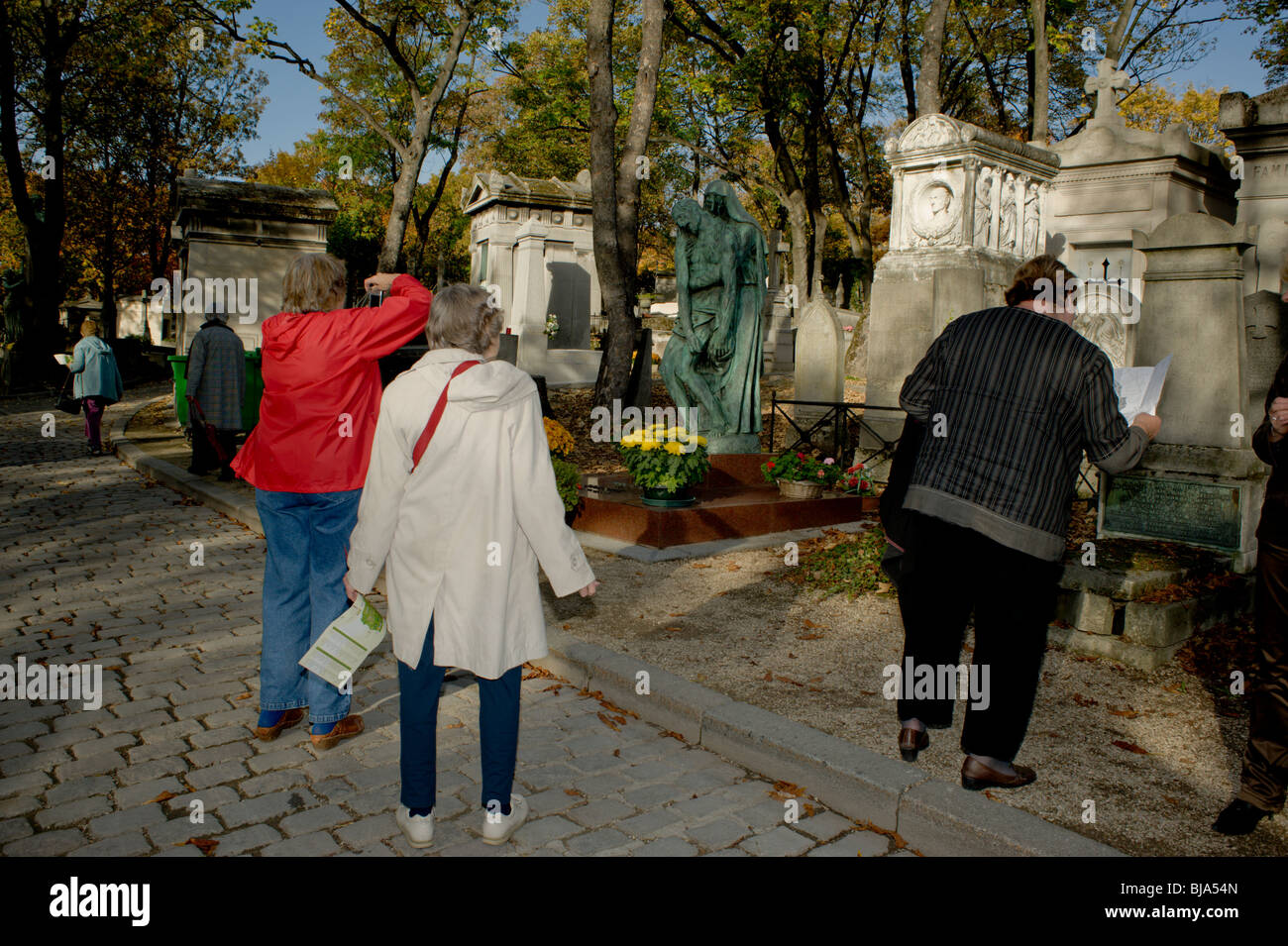 Paris, France - Women Visiting Urban Park, Pere Lachaise Cemetery, Graves Monument, historic holidays Stock Photo
