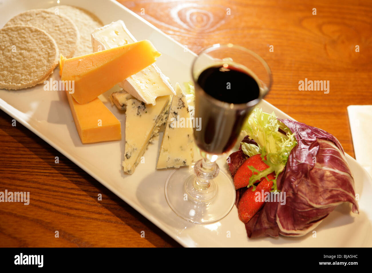 Glass of port and selection of cheeses on white platter Stock Photo Alamy