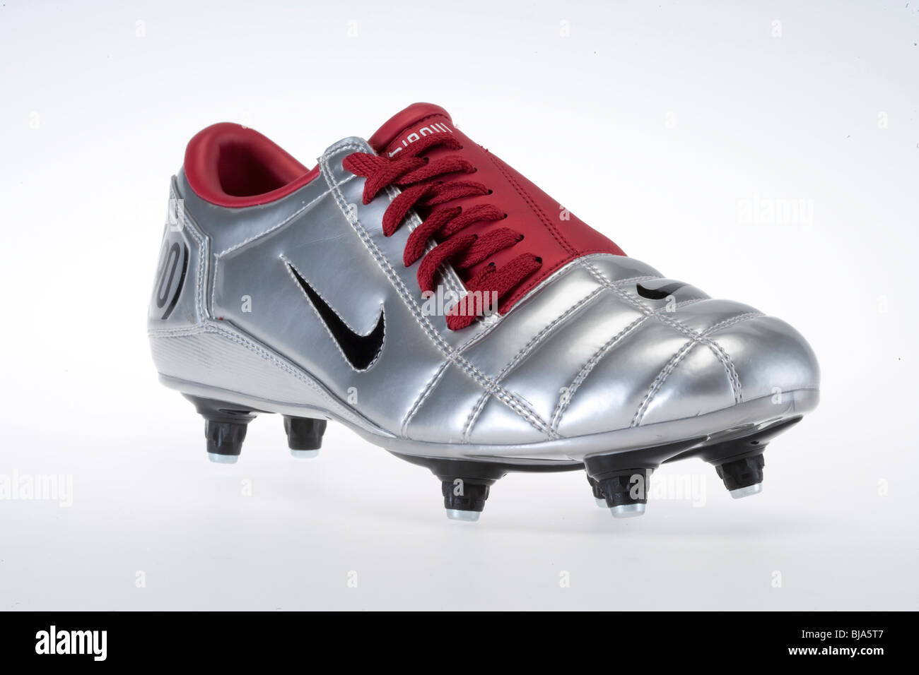 Silver and red Nike football trainer with black studs - front view Stock  Photo - Alamy
