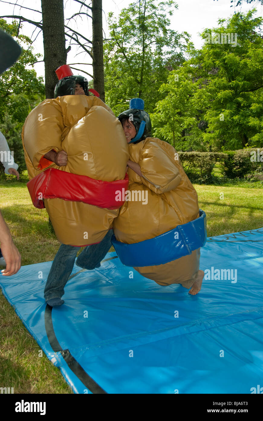Paris, France, Public Parks, Young People Wrestling Two Sumo Wrestlers in Huge Costumes, Play Fighting Outside in Fat Suits Stock Photo