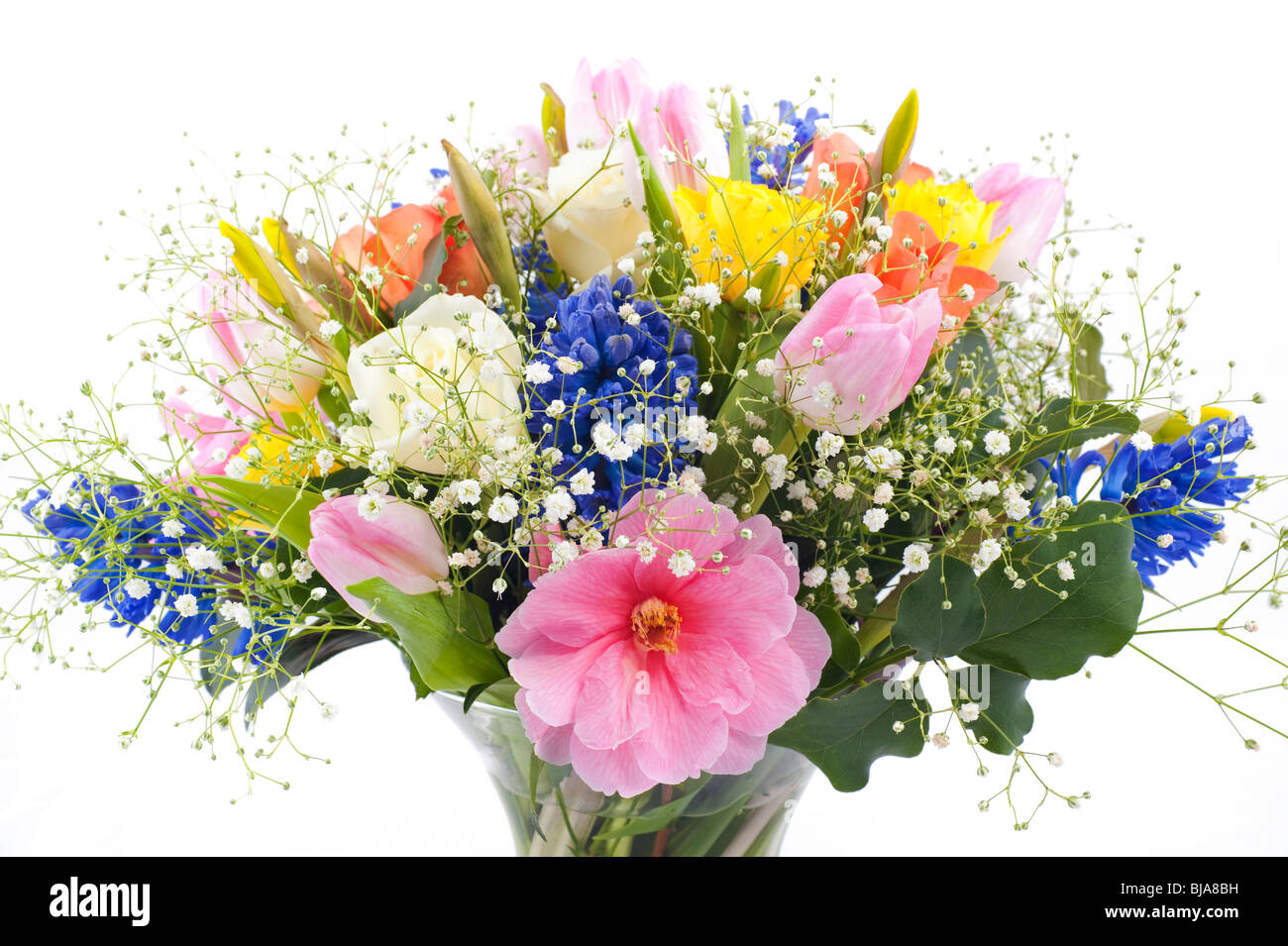 Spring flower arrangement in vase with roses, tulips hyacinth, daffodil