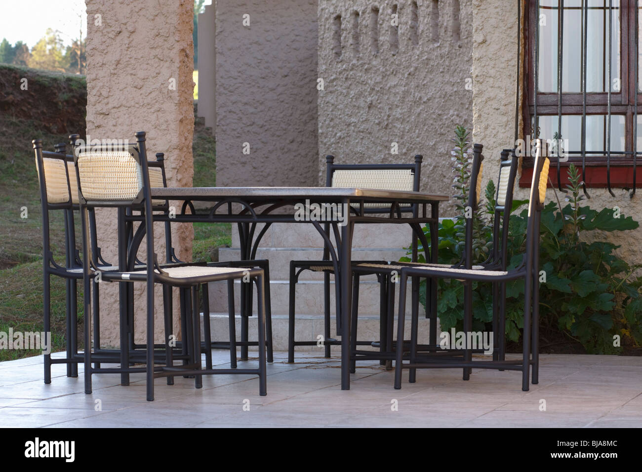 Patio furniture outside a Spanish styled villa. Stock Photo
