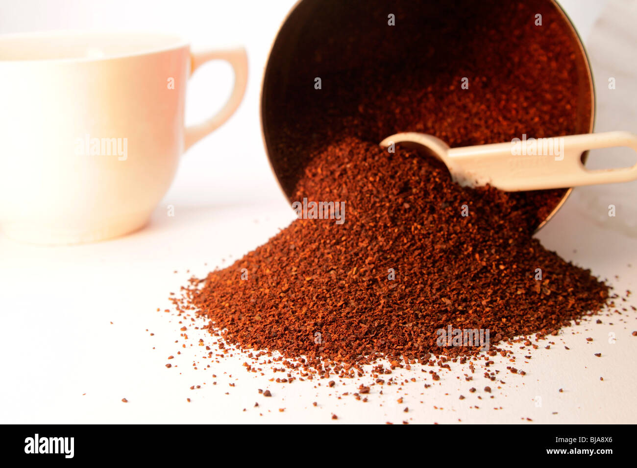 Rich ground roasted coffee with coffee measure and cup Stock Photo Alamy
