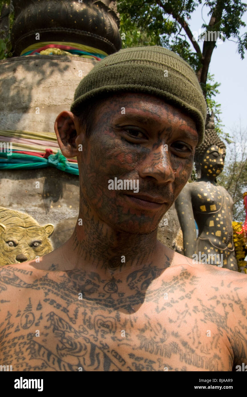 A young man´s sacred facial tattoos at Wat Bang Phra temple in Thailand, where monks tattoo devotees with protective prayers. Stock Photo