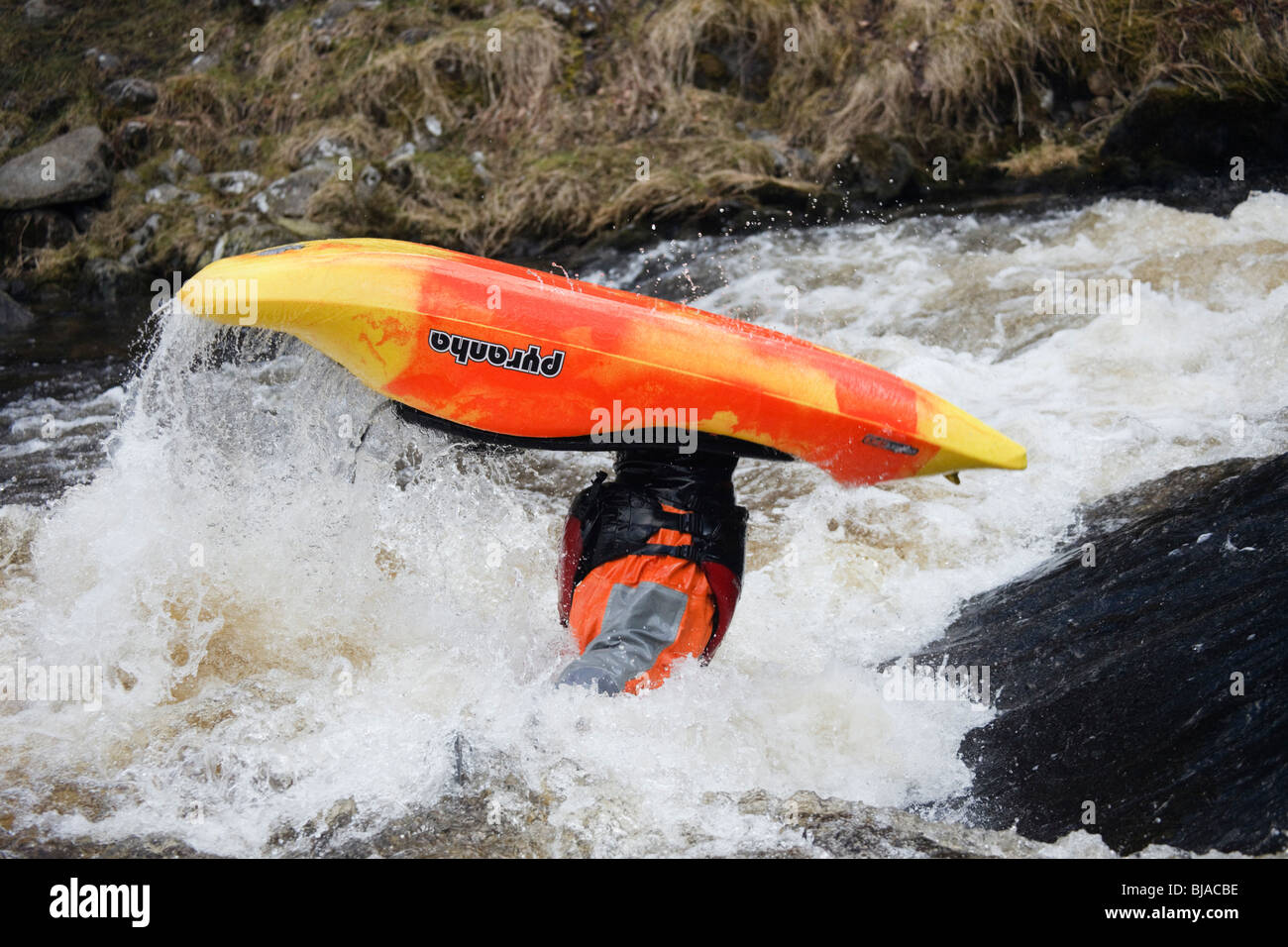 National Whitewater Centre North Wales UK Kayaker kayaking in Pyranah freestyle play kayak in white water on Tryweryn River Stock Photo