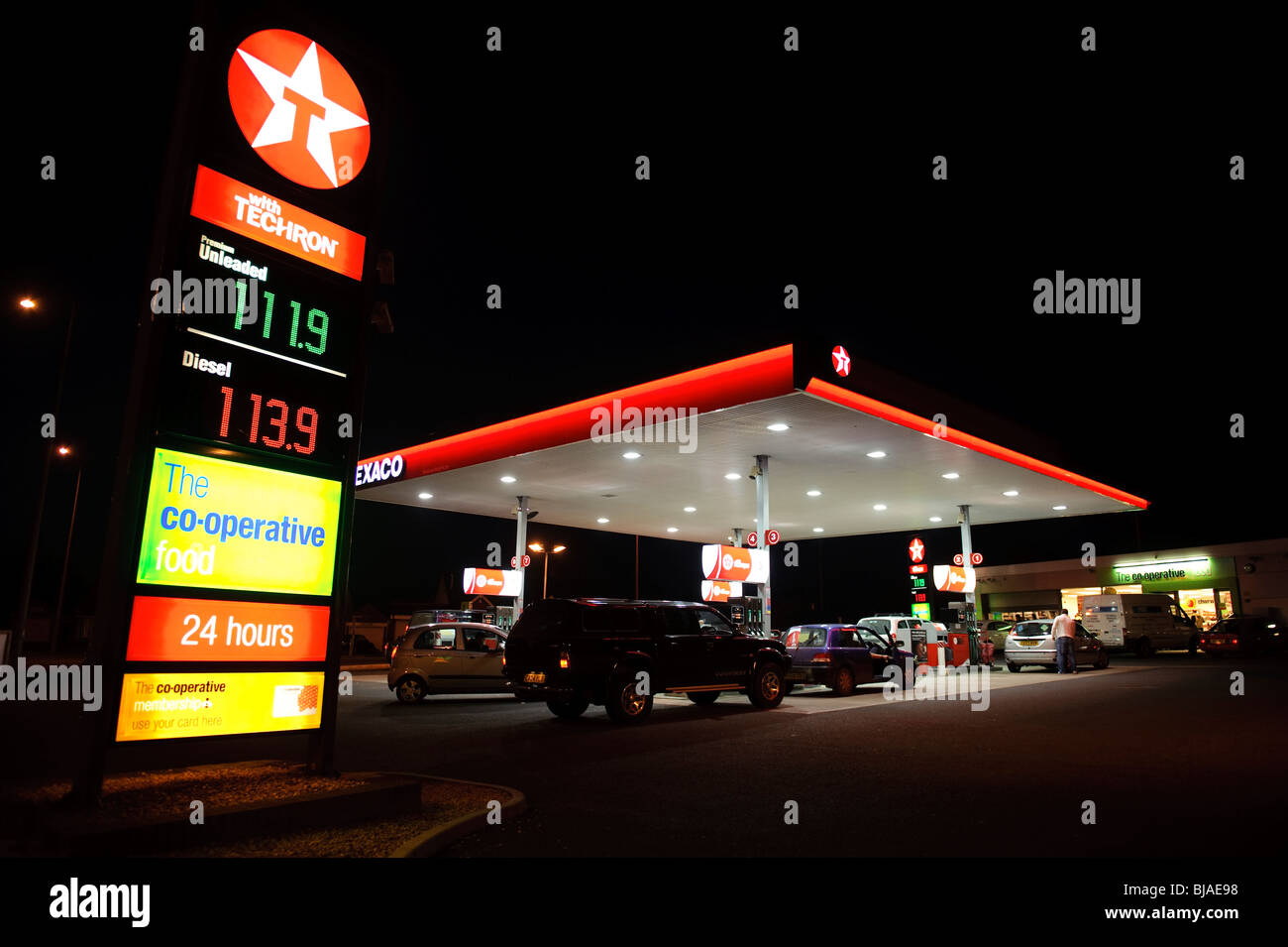 Texaco garage and CO-OP convenience store at night, UK Stock Photo