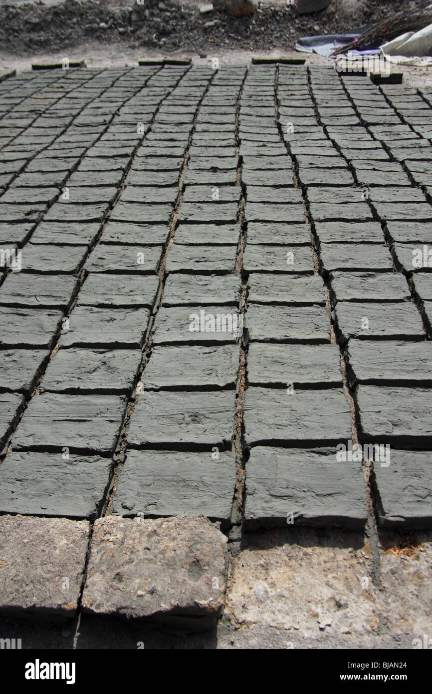 Display of handmade ceramic tiles laid so that they dry in the sun Stock Photo