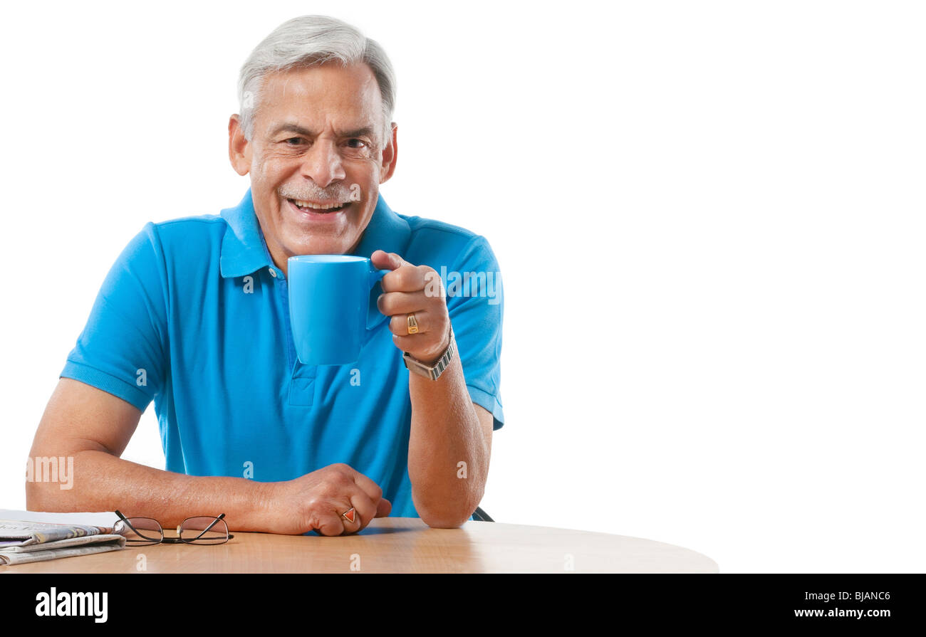 Old man having a cup of tea Stock Photo Alamy