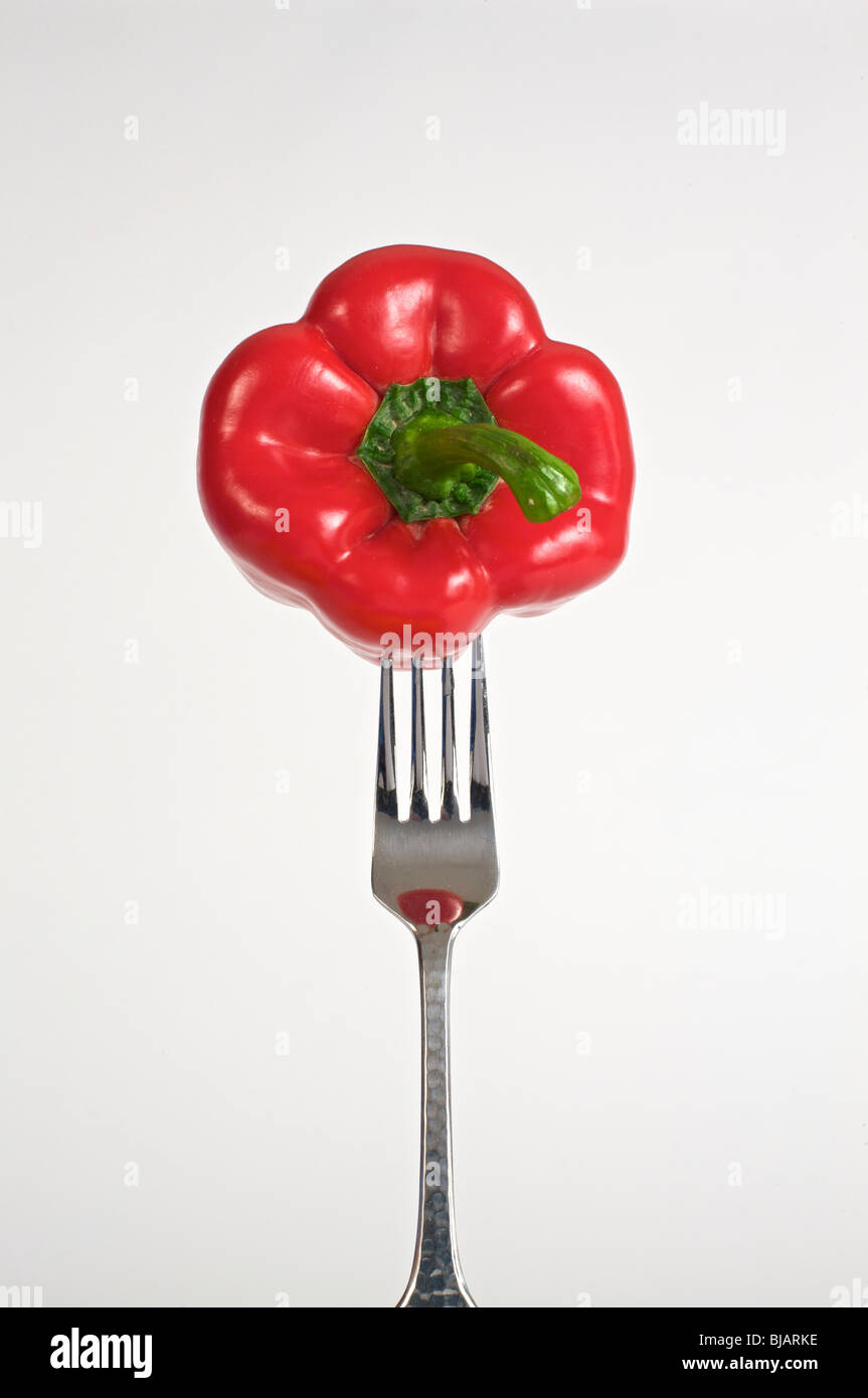 Food on your fork, a red bell pepper. on a fork on a white background. Stock Photo